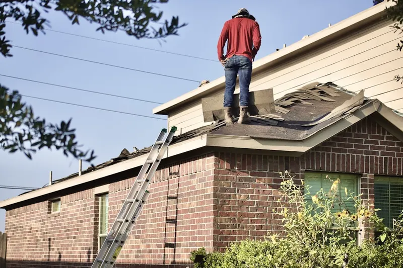 Professional roofer working on a residential roof in East Falls Church